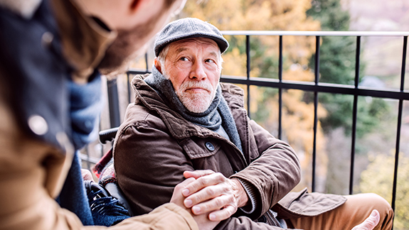 adult-son-caring-for-father-in-wheelchair-preventing-caregiver-burnou